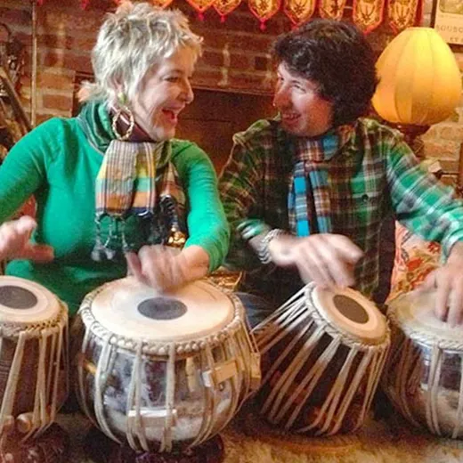 Two musicians playing tabla at a festival