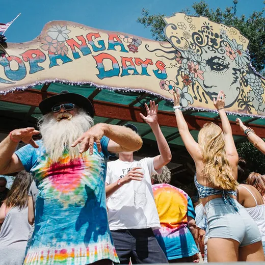 Crowd in tie-dye under the Topanga Days sign