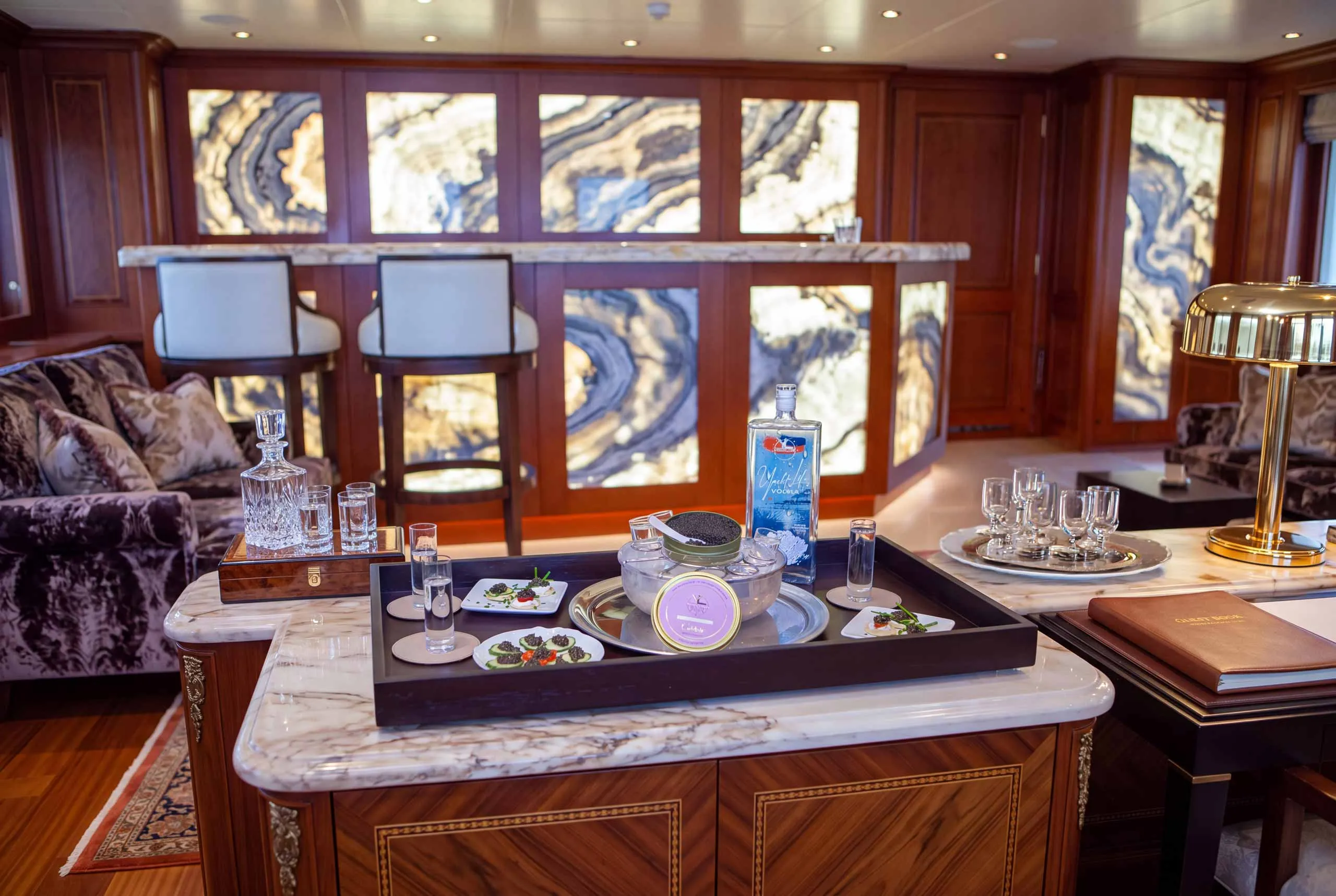 Yacht Life Vodka and caviar service on a marble sideboard in a superyacht salon